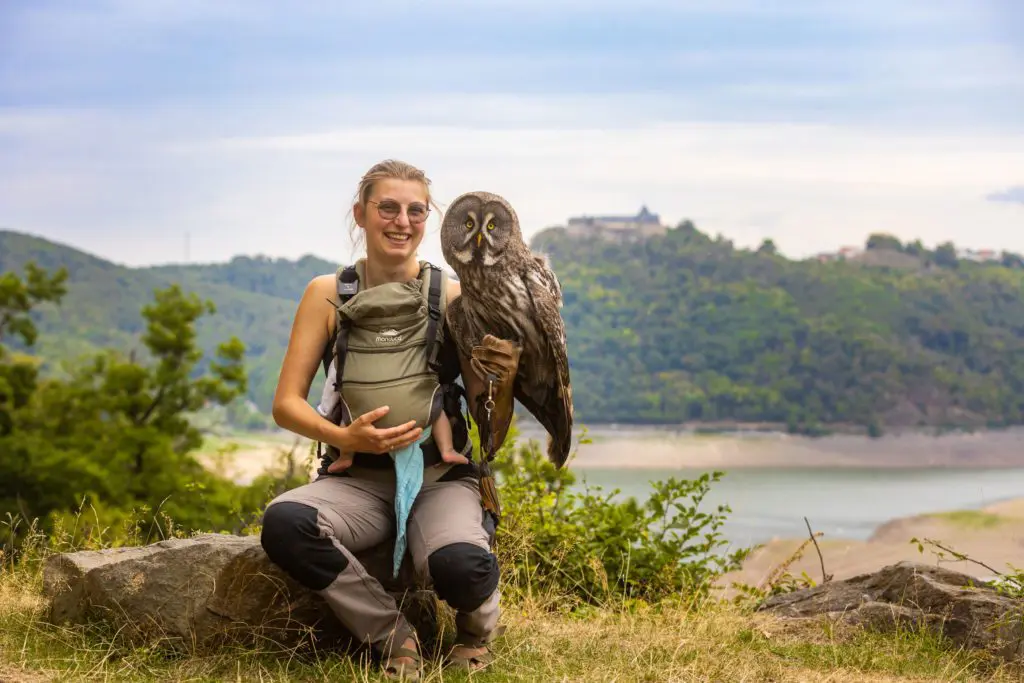 Falknerin Jana Zulauf an ihrem Lieblingsort auf einem Stein mittem im WildtierPark Edersee