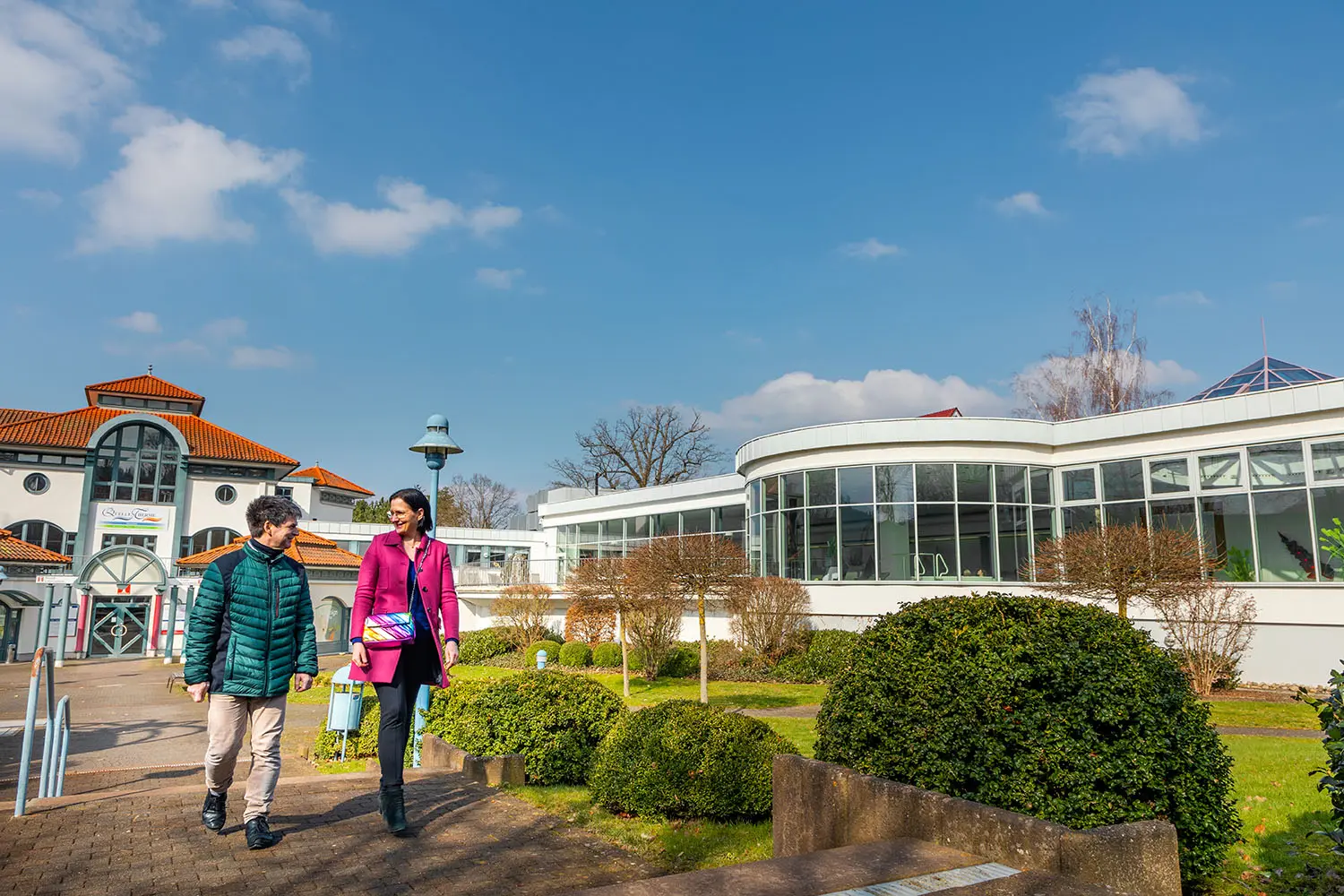 Zwei Personen laufen auf einem Weg bei der Quellentherme.
